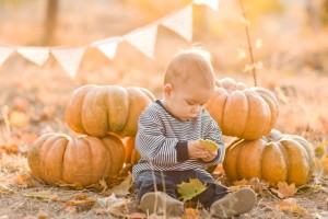 Baby in pumpkin patch