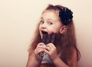 Child Enjoys Chocolate Bar